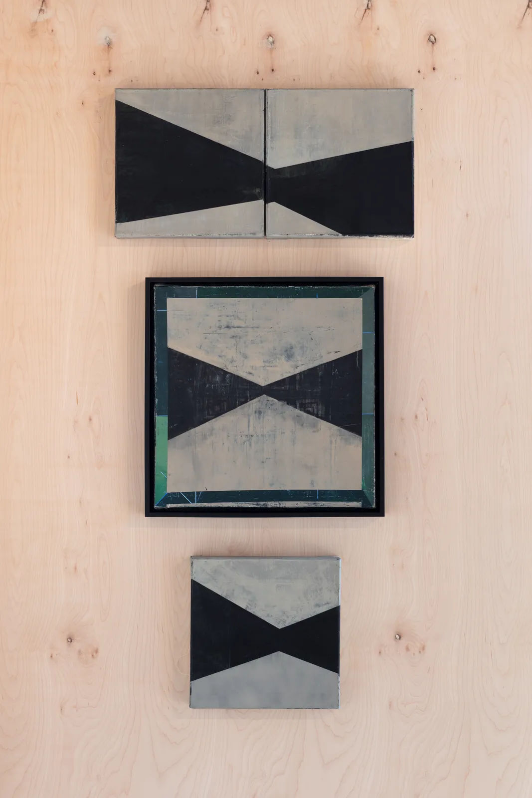 Three paintings from the X / sgraffito Cold Wax Series installed on a plywood wall